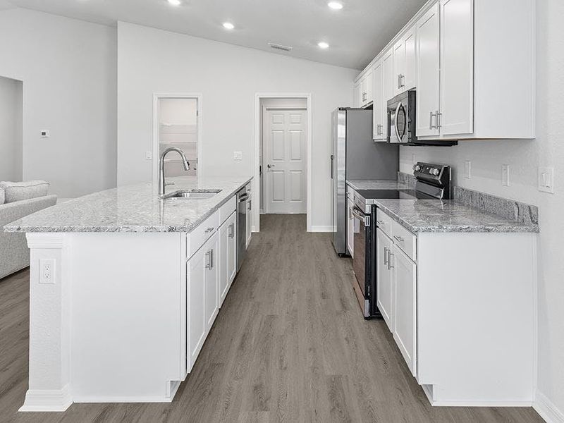 Enjoy a luxuriously appointed kitchen with granite, 36-inch cabinets, Samsung appliances, and a walk-in pantry.