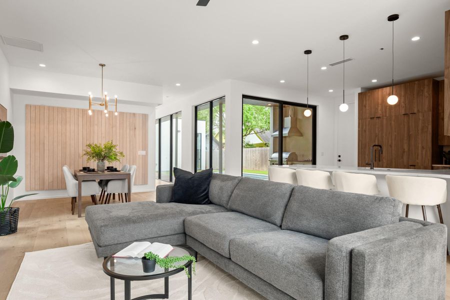 Living area with a chandelier and light wood-style flooring
