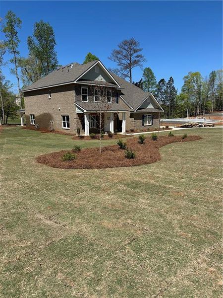 Front exterior of a new home in Mirror Lake at South Harbour, Villa Rica, GA, highlighting curb appeal (Image 18).