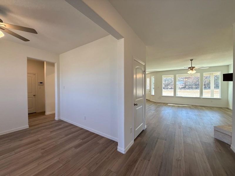 Spare room featuring a ceiling fan and dark wood finished floors
