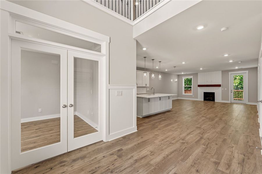 A spacious living area with warm wood-look floorin