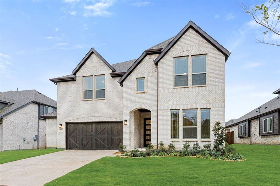 Front exterior of a new home in Windsong Ranch Classic 61, Prosper, TX, highlighting curb appeal (Image 2).