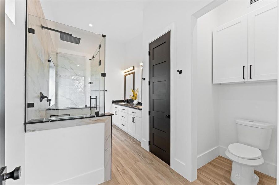 Primary bathroom with sleek modern finishes, a spacious layout, and high-end details create a spa-like retreat.