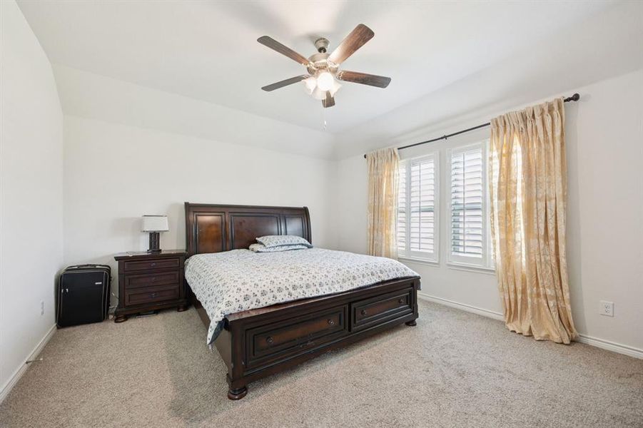 Bedroom featuring light carpet and a ceiling fan