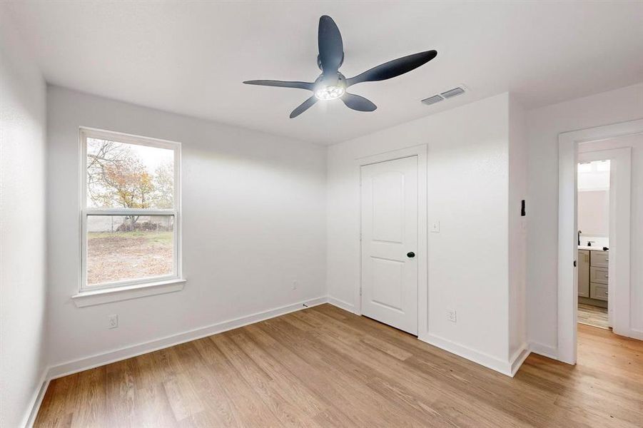 Unfurnished bedroom featuring light wood-type flooring, a closet, and ceiling fan