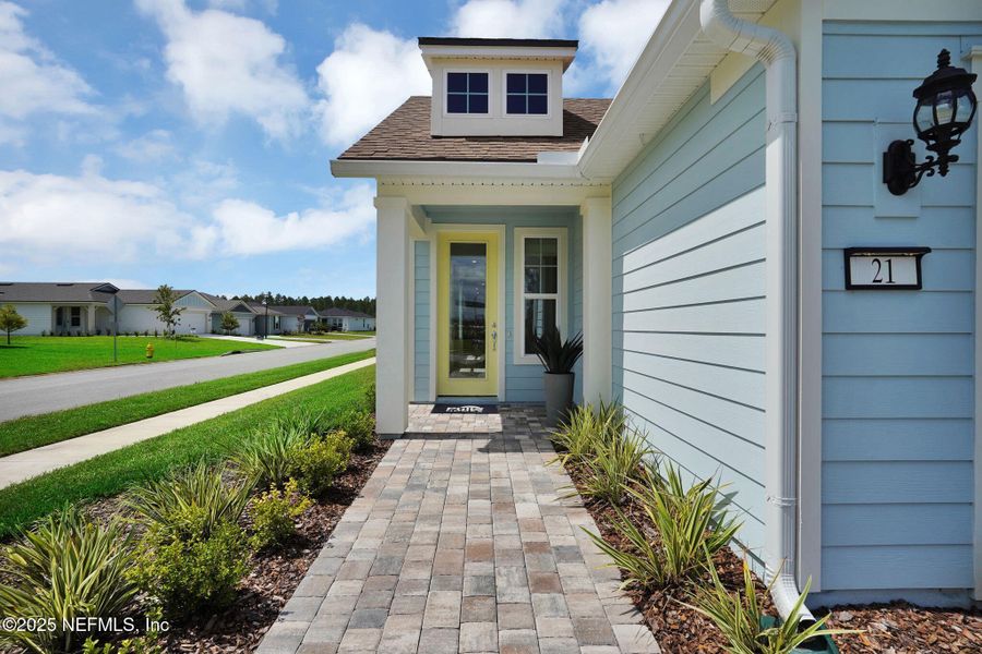 Front exterior of a new home in Summer Bay at Grand Oaks, St. Augustine, FL, highlighting curb appeal (Image 22).