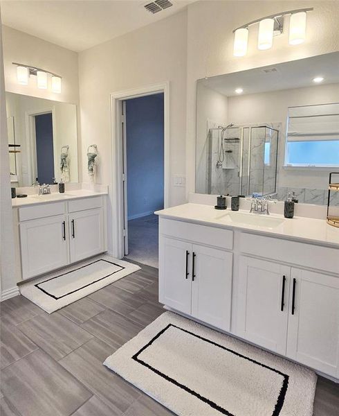 Primary bathroom with double vanities and includes linen closet.