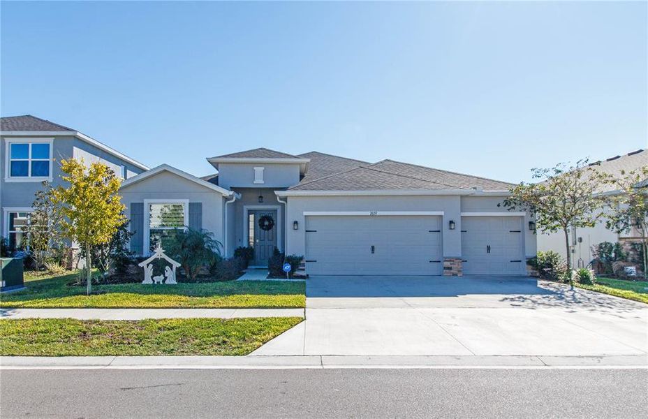 Front exterior of a new home in Deerbrook, Land O' Lakes, FL, highlighting curb appeal (Image 23). Front exterior of a new home in Deerbrook, Land O' Lakes, FL, highlighting curb appeal (Image 23).