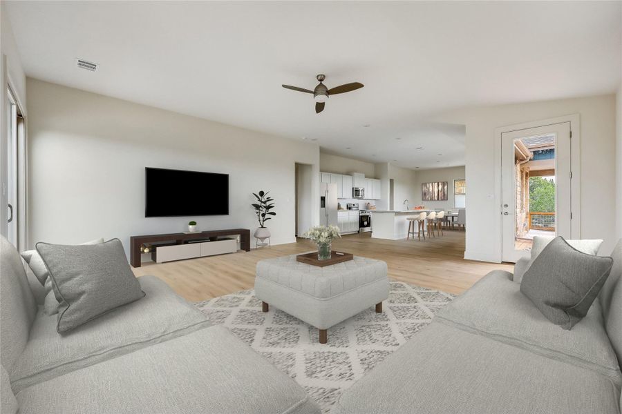 Living area featuring ceiling fan and light wood-style floors