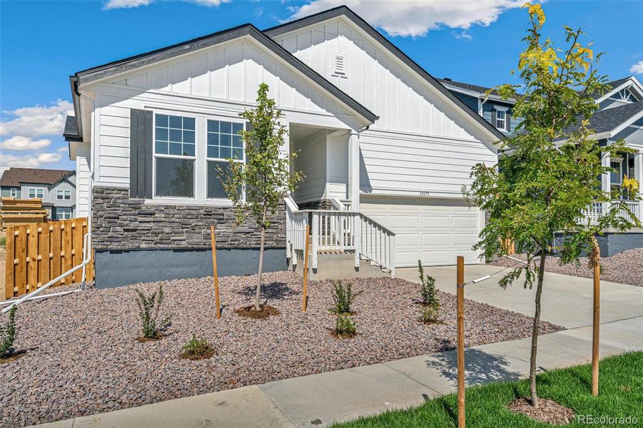 Front exterior of a new home in Turnberry, Commerce City, CO, highlighting curb appeal (Image 20).