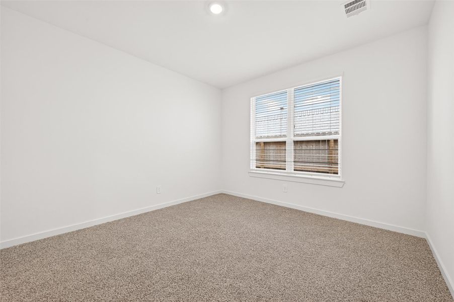 Home Office: A spacious home office with double doors and a front-facing window offers the perfect workspace!