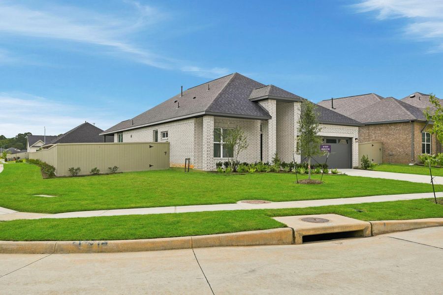 Front exterior of a new home in Audubon, Magnolia, TX, highlighting curb appeal (Image 22). Front exterior of a new home in Audubon, Magnolia, TX, highlighting curb appeal (Image 22).