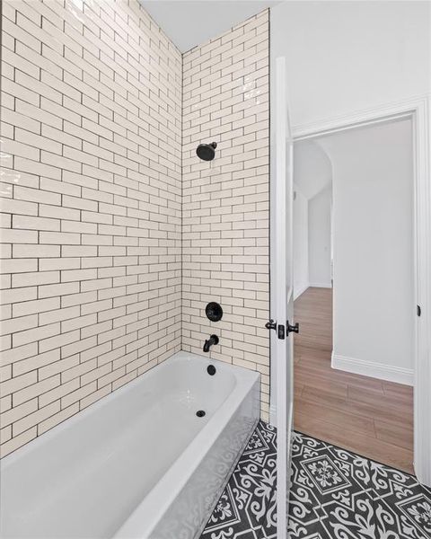 Full bathroom featuring shower / washtub combination and wood finished floors
