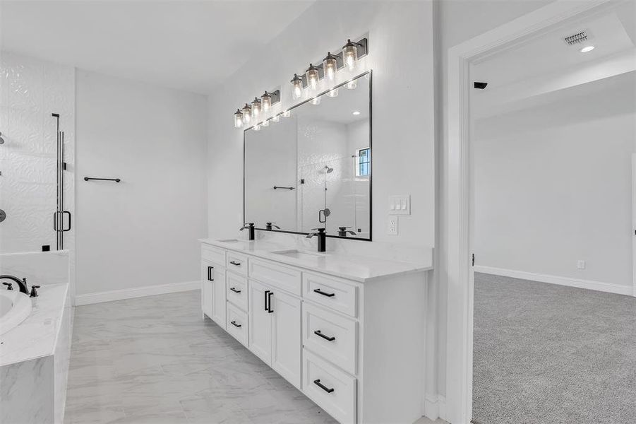 Bathroom featuring separate shower and tub, tile patterned floors, and vanity