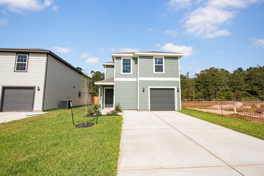 Front exterior of a new home in Townsend Reserve, Splendora, TX, highlighting curb appeal (Image 1). Front exterior of a new home in Townsend Reserve, Splendora, TX, highlighting curb appeal (Image 1).