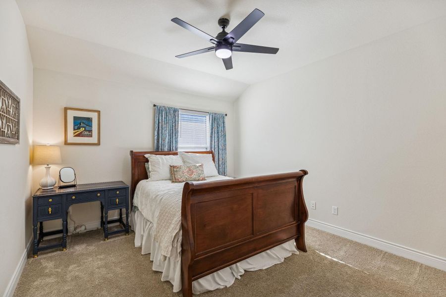 Third bedroom upstairs with ceiling fan and carpet
