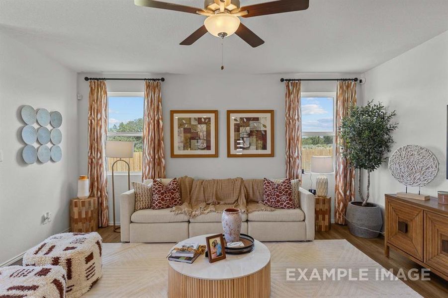 Living room with light hardwood / wood-style floors and ceiling fan