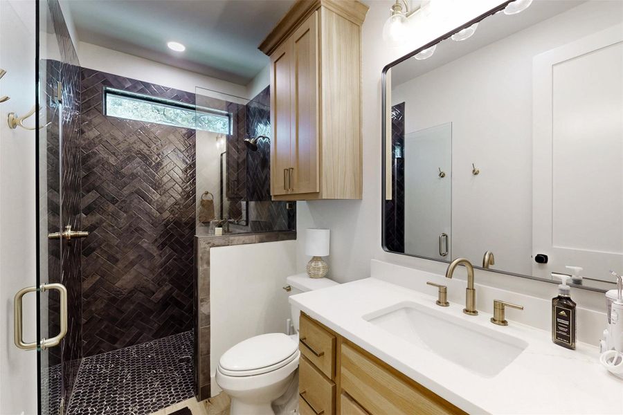 Full bath featuring vanity, a shower stall, and recessed lighting