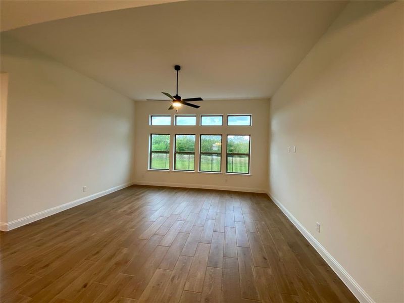 Wall of windows in family room looks out to back yard and lush Greenspace Wall of windows in family room looks out to back yard and lush Greenspace