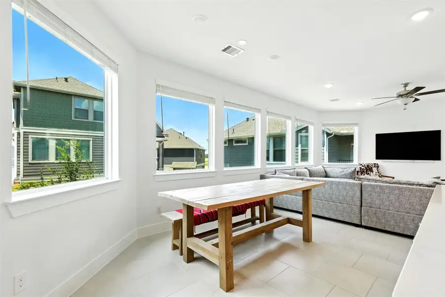 This dining room is bathed in naturallight streaming through expansivewindows. This dining room is bathed in naturallight streaming through expansivewindows.