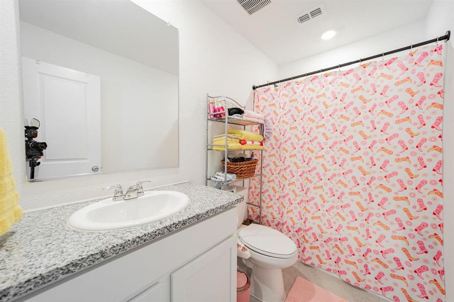 Full bath with vanity and a shower with shower curtain