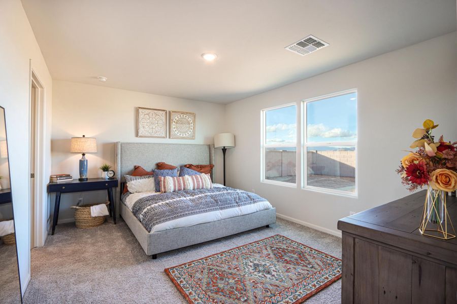 A bedroom with a large window.