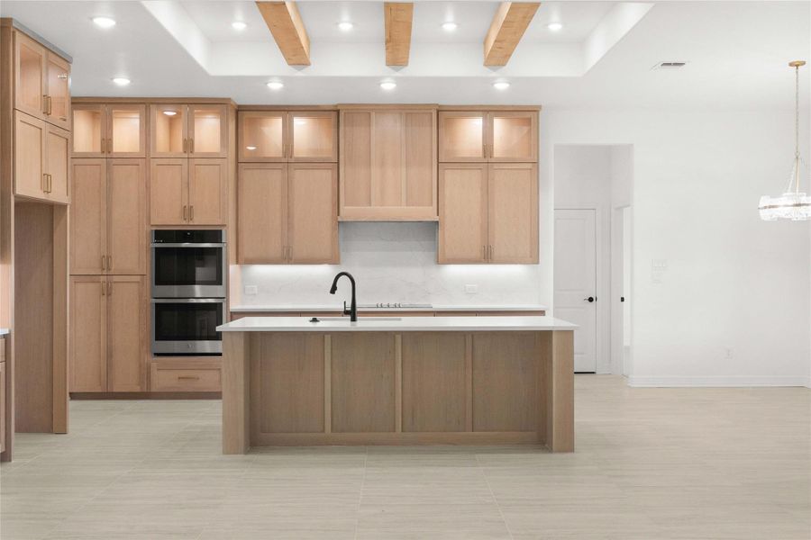 A contemporary kitchen features warm wood cabinetry, a functional island, and integrated stainless steel appliances. A contemporary kitchen features warm wood cabinetry, a functional island, and integrated stainless steel appliances.