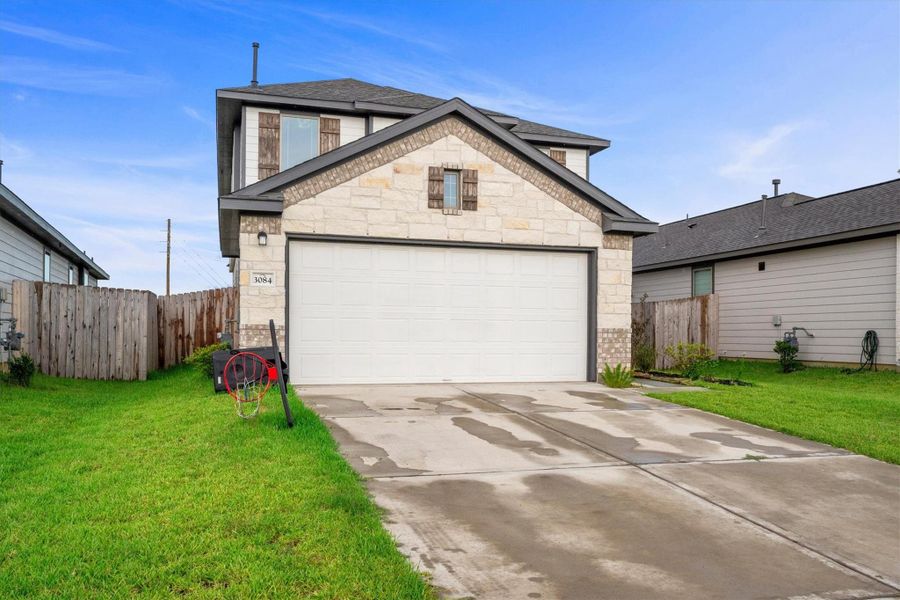 Front exterior of a new home in Bluestem, Brookshire, TX, highlighting curb appeal (Image 1). Front exterior of a new home in Bluestem, Brookshire, TX, highlighting curb appeal (Image 1).