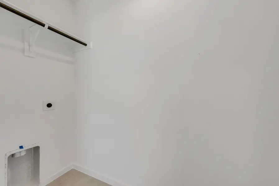 Laundry area with electric dryer hookup and light wood-type flooring