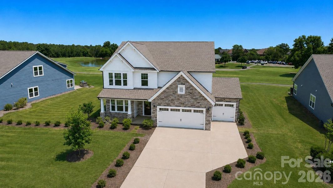 Front exterior of a new home in Stonebridge Fairways, Monroe, NC, highlighting curb appeal (Image 1). Front exterior of a new home in Stonebridge Fairways, Monroe, NC, highlighting curb appeal (Image 1).