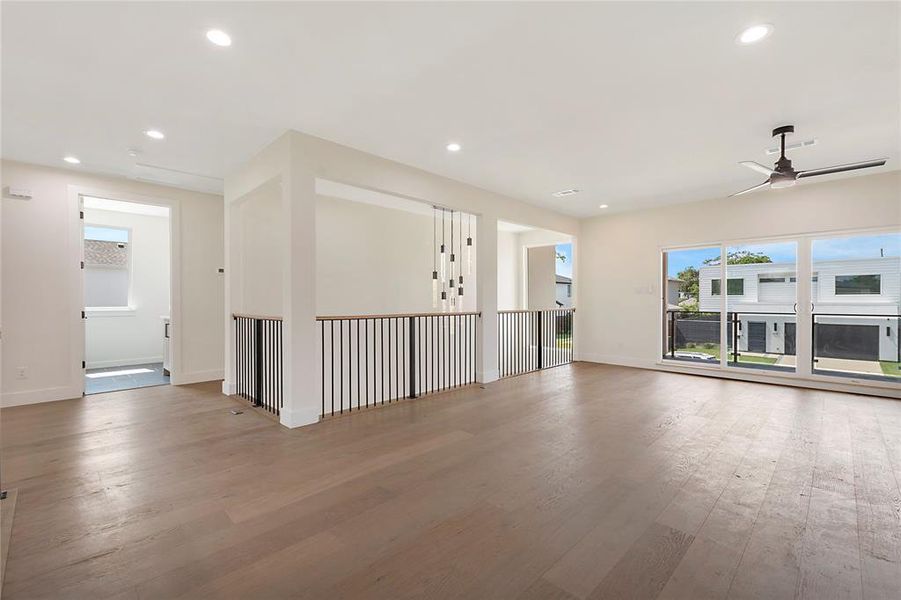 Empty room with ceiling fan and hardwood / wood-style floors