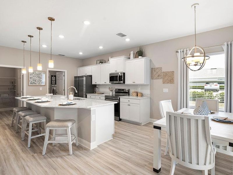 Your new kitchen is beautifully designed with quartz, 36-inch cabinets, Samsung SS appliances, a tiled backsplash, and designer light fixtures.
