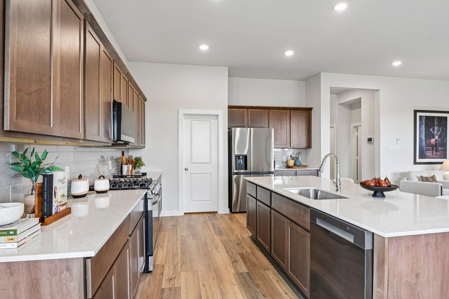 A kitchen with wooden cabinets.