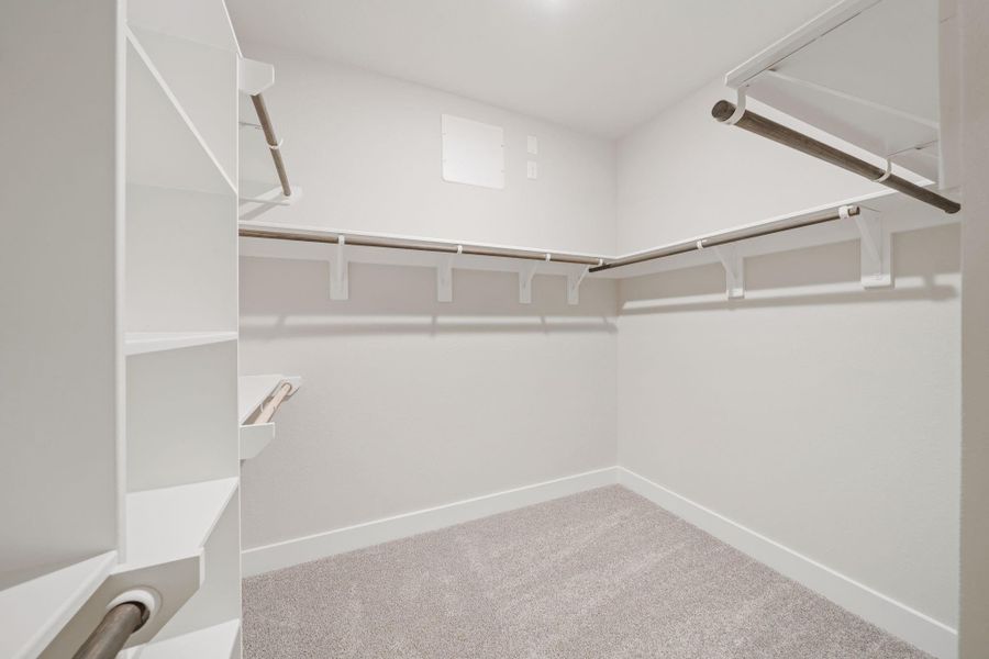 A stylish walk-in closet awaits, providing ample storage for your wardrobe and a built-in shelving for those cherished items. A stylish walk-in closet awaits, providing ample storage for your wardrobe and a built-in shelving for those cherished items.