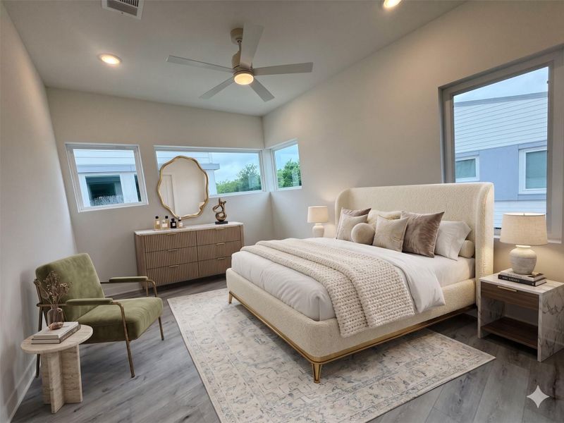 This is a bright, modern bedroom featuring large windows, a cozy bed with plush pillows, a stylish dresser, and a comfortable armchair. The neutral color palette and elegant decor create a relaxing atmosphere.