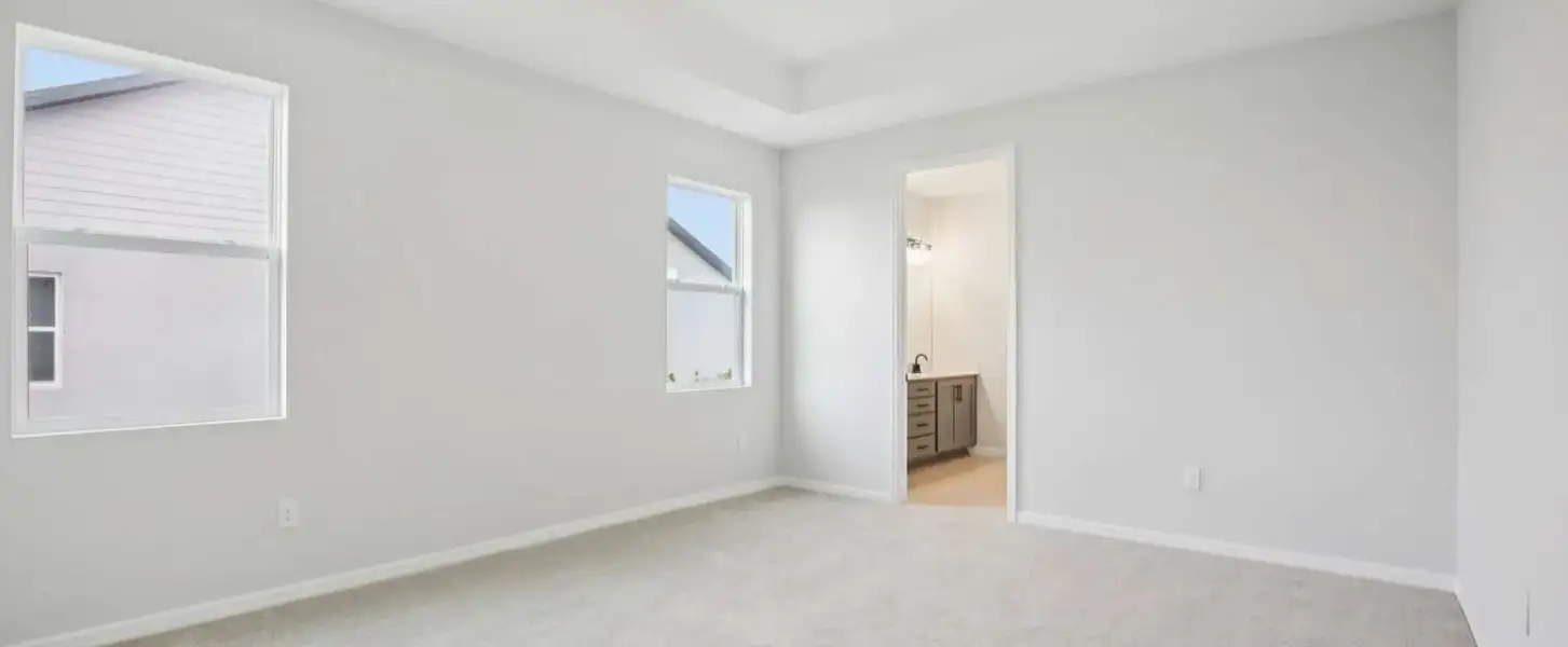 Primary bedroom featuring a tray ceiling - Representative images and renderings are for illustrative purposes. Actual structural options and design finishes of home may vary.