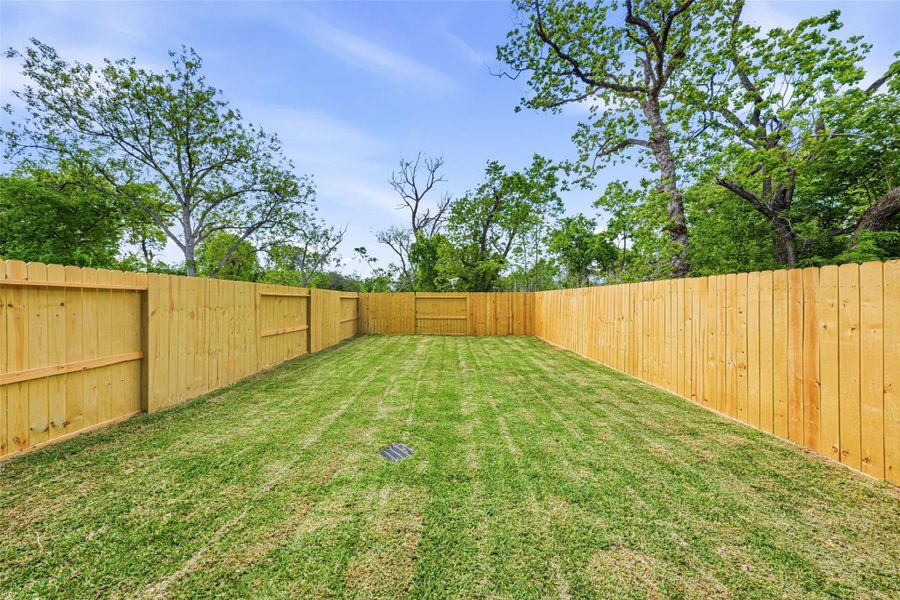 This large backyard is completely fenced in. There’s room for the dog to run around, with plenty of space to lounge, host BBQ, and entertain.