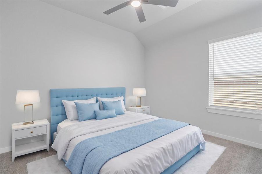 Secondary bedroom features plush carpet, neutral paint, ceiling fan, and a large window with privacy blinds.