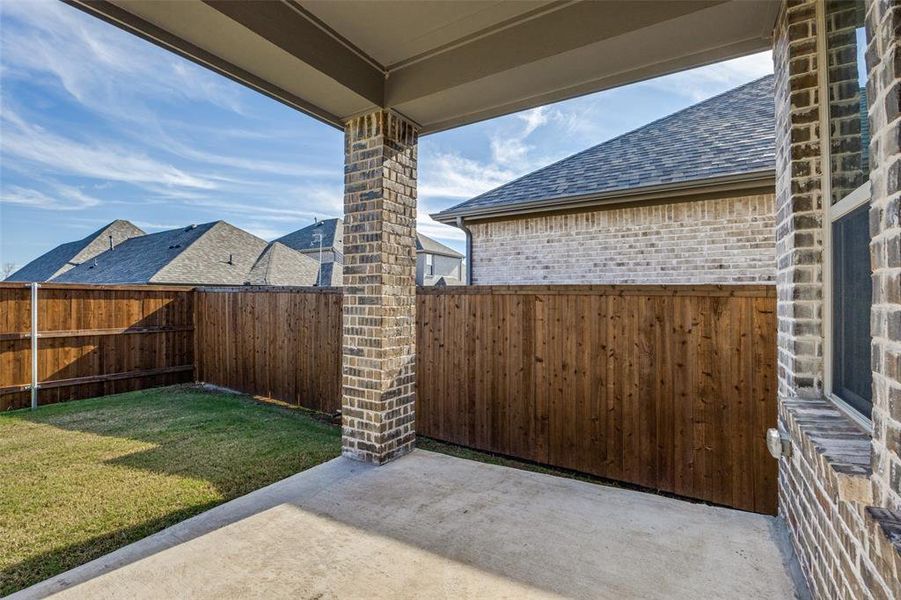 Fenced backyard featuring a patio