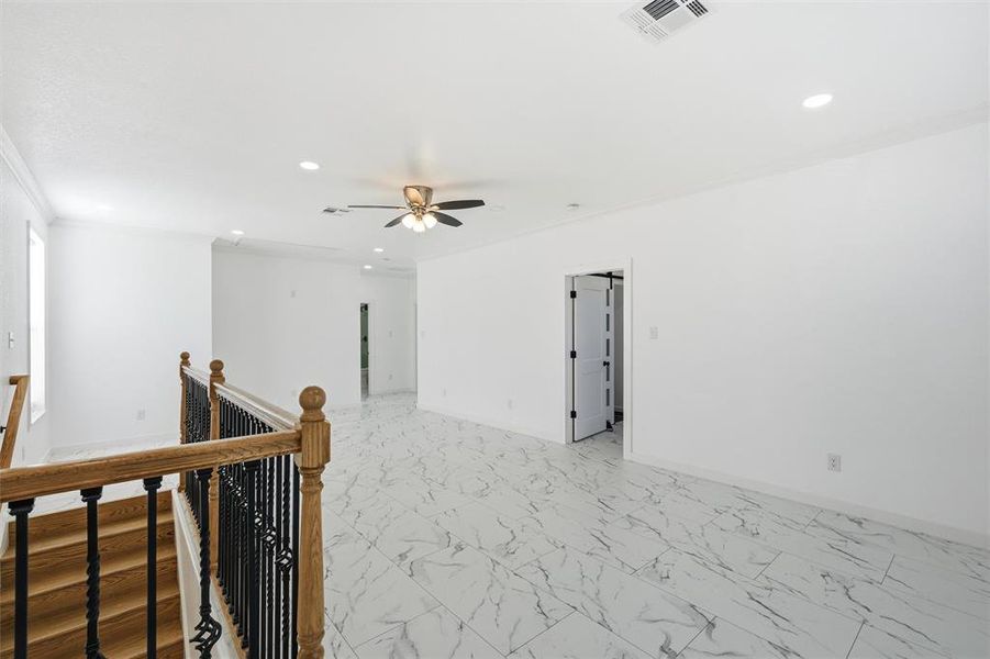 Empty room featuring light marble finish flooring, crown molding, recessed lighting, and ceiling fan Empty room featuring light marble finish flooring, crown molding, recessed lighting, and ceiling fan