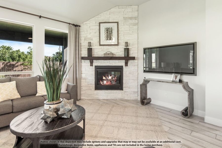 Living room with white stacked stone fireplace, wood mantel, vaulted ceiling, and large windows