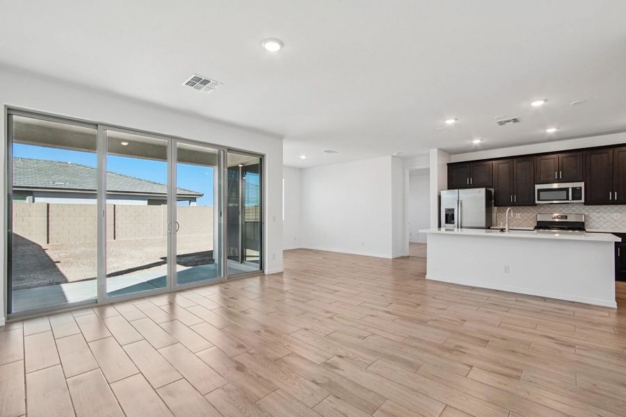 Great room, kitchen and dining. Not actual home, finishes and options may vary.