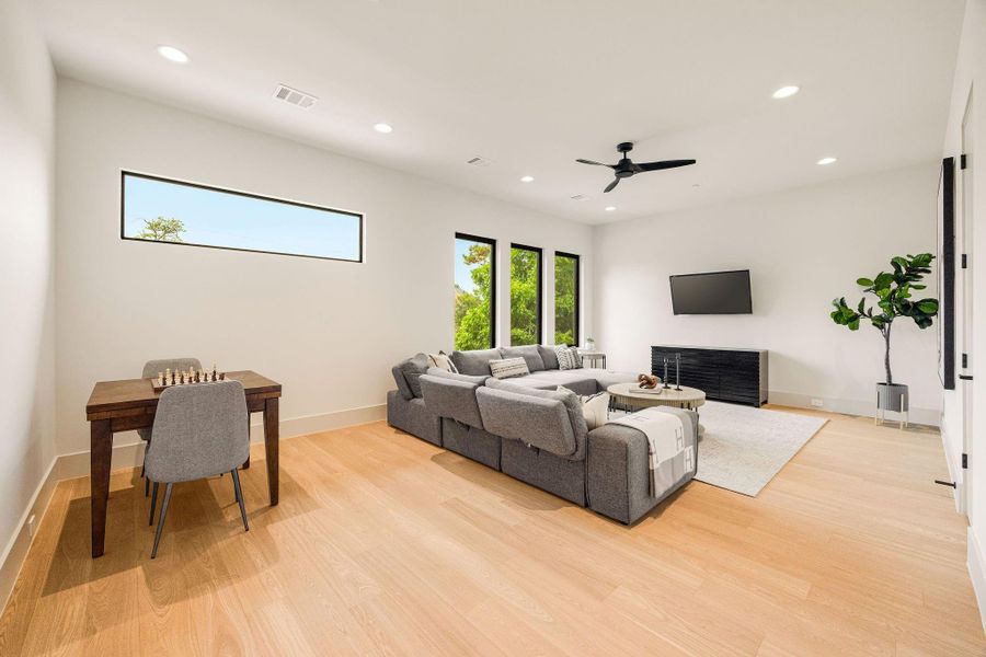 [GAME ROOM] Designed as a versatile gathering space, the generous game room is filled with abundant natural light from expansive windows, creating a bright and welcoming setting for entertainment and everyday enjoyment.