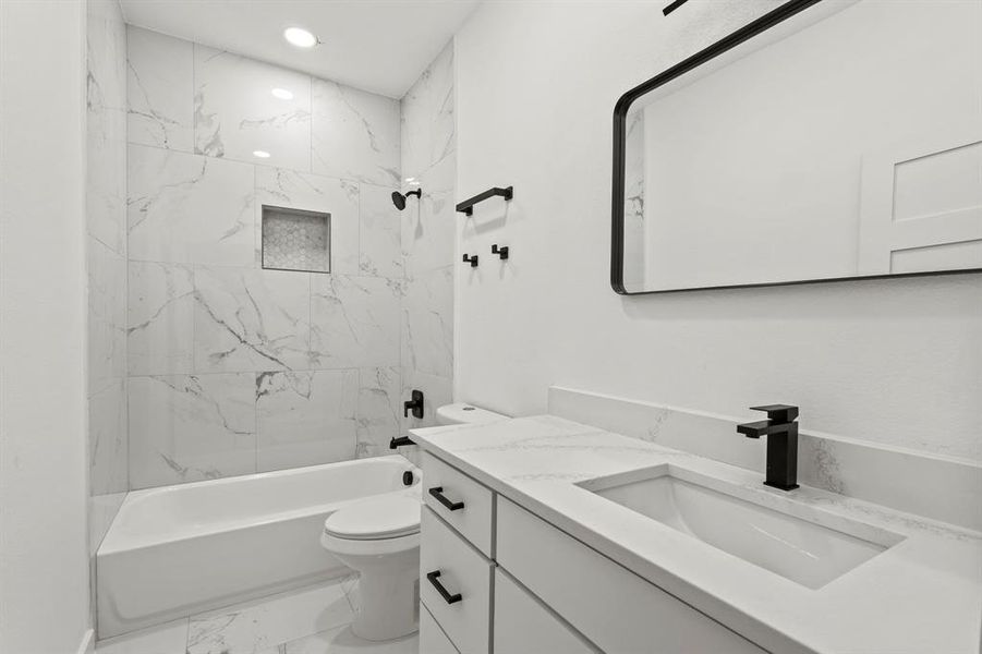 Full bath featuring vanity, marble finish floors, toilet, bathtub / shower combination, and recessed lighting Full bath featuring vanity, marble finish floors, toilet, bathtub / shower combination, and recessed lighting