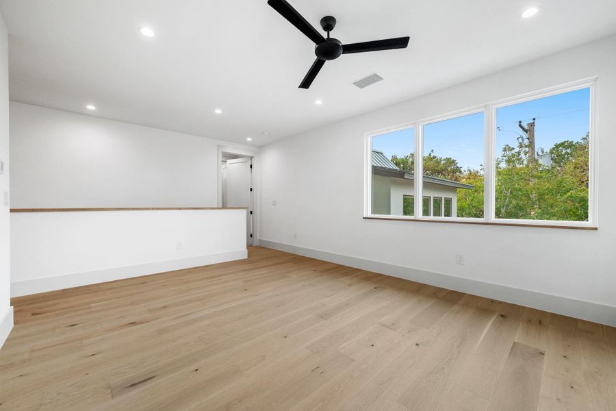 Spare room with light wood-style flooring, recessed lighting, and a ceiling fan Spare room with light wood-style flooring, recessed lighting, and a ceiling fan