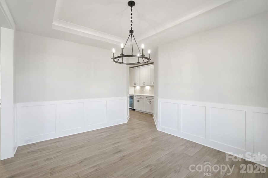 Dining room with tray ceiling & wainscoting