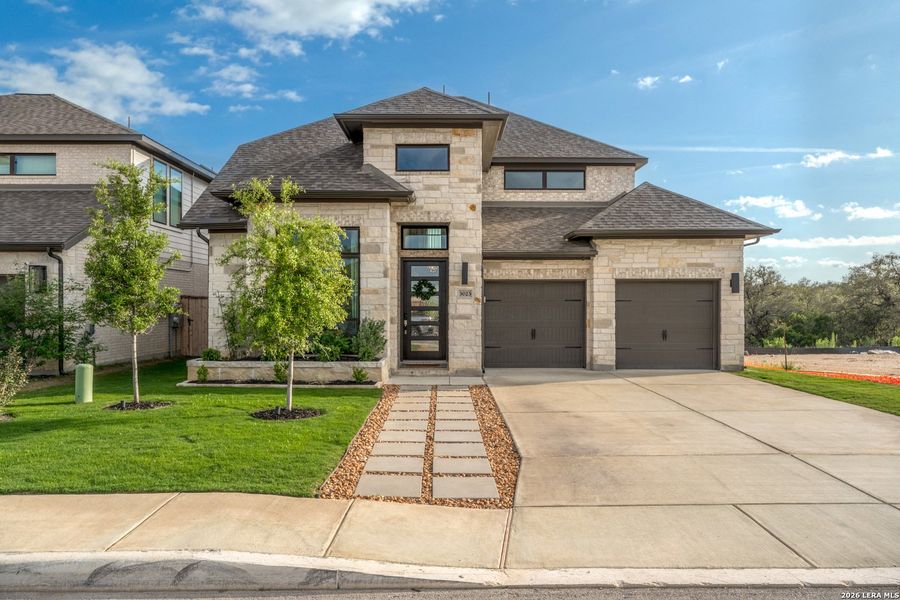 Front exterior of a new home in Ladera, San Antonio, TX, highlighting curb appeal (Image 2). Front exterior of a new home in Ladera, San Antonio, TX, highlighting curb appeal (Image 2).