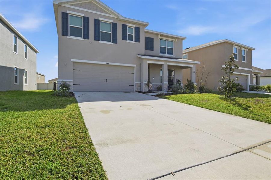 Front exterior of a new home in Farm at Varrea, Plant City, FL, highlighting curb appeal (Image 22).