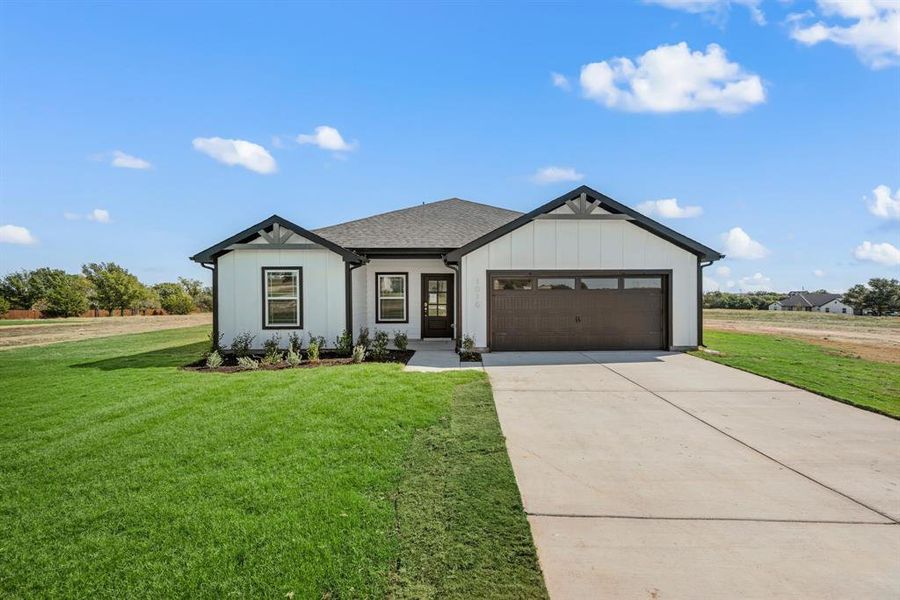 Front exterior of a new home in Gatlin Ranch, Springtown, TX, highlighting curb appeal (Image 1). Front exterior of a new home in Gatlin Ranch, Springtown, TX, highlighting curb appeal (Image 1).