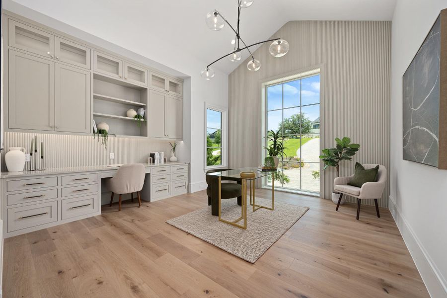 Custom built-ins and towering windows define this sun-drenched home office, offering a productive and inspiring workspace.